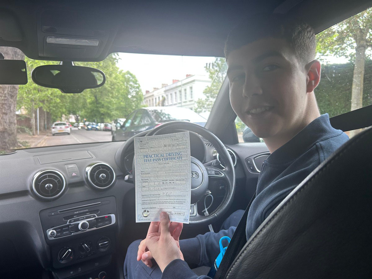 Learner holding a practical driving test pass certificate after passing with A2Z Drive
